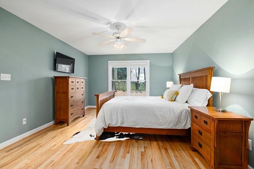 Cowhides Direct Genuine Cowhide Rug - Black & White Rug for Living Room, Bedroom & More - Authentic Cow Rug (6’x7’ Black & White) in Teal and Orange Wood Bedroom