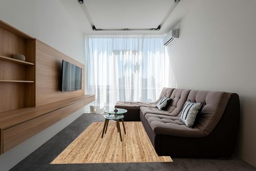 NuLOOM Rigo Hand Woven Farmhouse Jute Area Rug, 6' x 9', Natural in Grey Living Room with Brown Couch