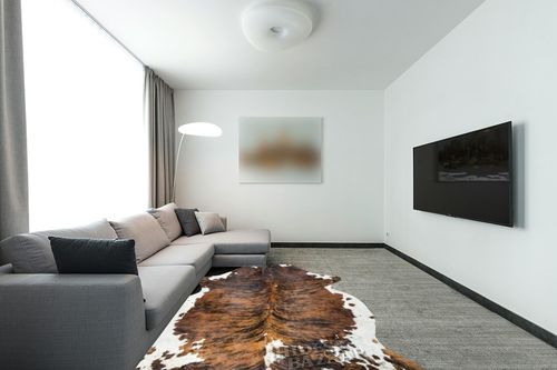 HIDES BAZAAR Brown Brindle Cowhide Rug, Premium Quality Genuine Leather Cow Hide, Brown, Black and White Area Rug (6x8 ft) in Modern Living Room with Grey Couch