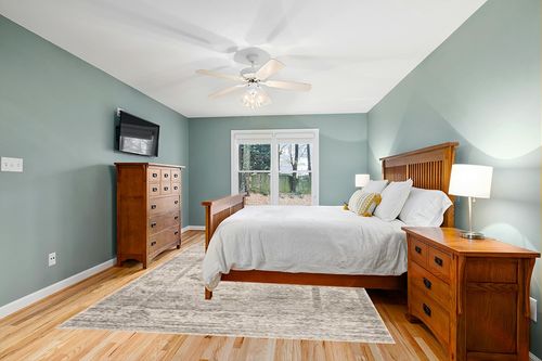 Loloi Magnolia Home by Joanna Gaines x Millie Silver/Dove 7'-10" x 10' Area Rug in Teal and Orange Wood Bedroom