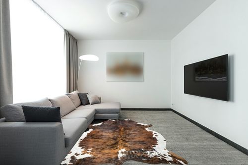 HIDES BAZAAR Brown Brindle Cowhide Rug, Premium Quality Genuine Leather Cow Hide, Brown, Black and White Area Rug (6x7 ft) in Modern Living Room with Grey Couch