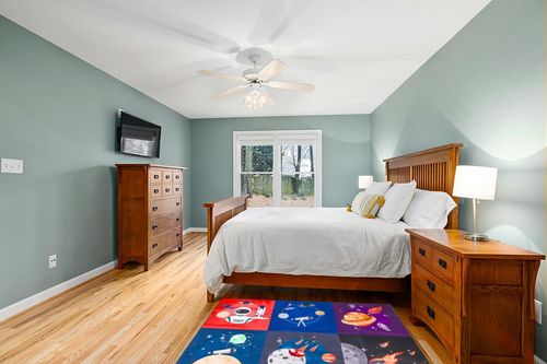 Prosumer's Choice Kids Space Themed Black Wool Rug - Non-Slip, Soft, and Durable | Perfect for Bedrooms, Playrooms, Nurseries | Solar System and Rocket Ship Design - 62.9'' x 47.2'' in Teal and Orange Wood Bedroom