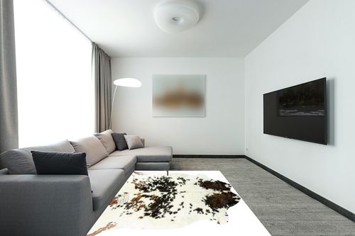 HIDES BAZAAR Light Tricolor Cowhide Rug, Premium Quality Genuine Leather Cow Hide, White, Brown and Black Color Mix Area Rug (6x7 ft) in Modern Living Room with Grey Couch