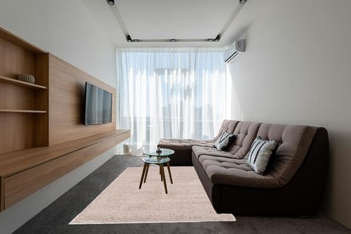 Unique Loom Solid Shag Collection Area Rug (6' 1" x 9' Rectangle, Taupe) in Grey Living Room with Brown Couch