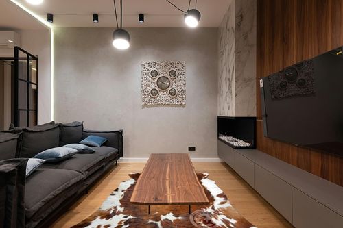 Sunshine Cowhides Genuine Brindle Tricolor Cowhide Rug - Luxurious Cow Rug for Bedroom, Living Room, and Home Decor Enthusiasts - Masterpiece of Style and Functionality - XL 6x7-8ft (180x220cm) in Dark Wood Living Room with Black Couch