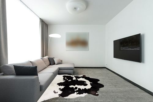 Cowhides Direct Genuine Cowhide Rug - Black & White Rug for Living Room, Bedroom & More - Authentic Cow Rug (6’x7’ Black & White) in Modern Living Room with Grey Couch