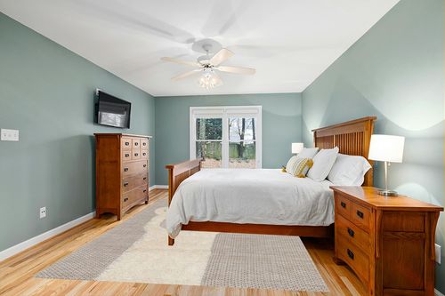 Valetta Abstract Beige Area Rug Isabelle & Max Rug Size: Rectangle 7'10" x 10'10" in Teal and Orange Wood Bedroom