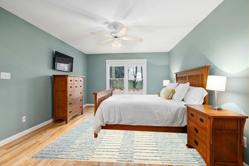 Loloi Chris Loves Julia x Chris Ivory/Denim 8'-6" x 11'-6" Area Rug in Teal and Orange Wood Bedroom