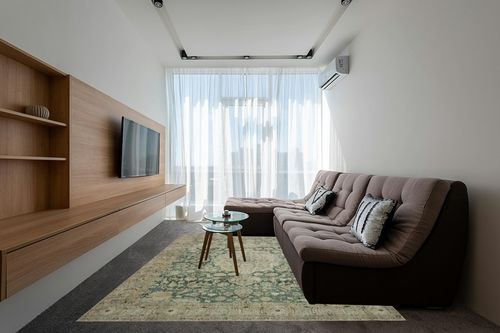 Magnolia Home by Joanna Gaines x Loloi Sinclair Collection SIN-05 Jade / Sand 7'-6" x 9'-6" Area Rug in Grey Living Room with Brown Couch