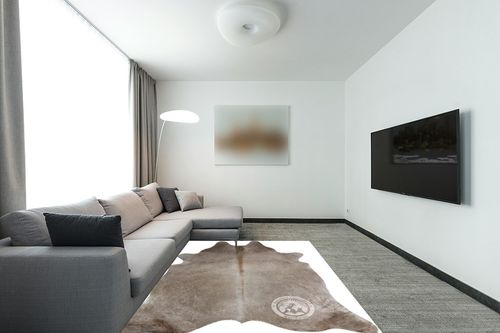 Sunshine Cowhides Genuine Taupe Cowhide Rug - Luxurious Cow Rug for Bedroom, Living Room, and Home Decor Enthusiasts - Masterpiece of Style and Functionality - 6x6-7ft (180x210cm) in Modern Living Room with Grey Couch