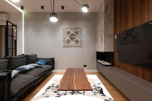 nuLOOM Iraida Contemporary Faux Cowhide Area Rug, 5' x 6' 7", Black in Dark Wood Living Room with Black Couch