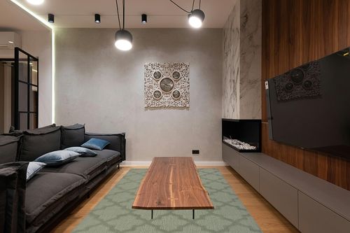 Garland Rug Quatro 6 ft. x 9 ft. Area Rug Sage in Dark Wood Living Room with Black Couch