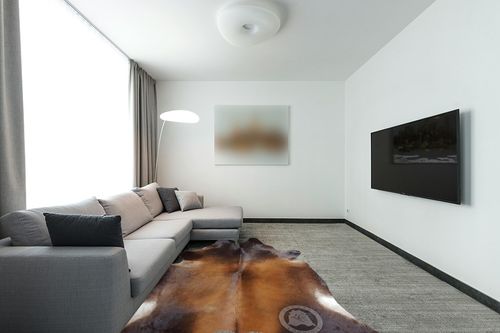 Sunshine Cowhides Genuine Mahogany Brown Cowhide Rug - Luxurious Cow Rug for Bedroom, Living Room, and Home Decor Enthusiasts - Masterpiece of Style and Functionality - XL 6x7-8ft (180x240cm) in Modern Living Room with Grey Couch