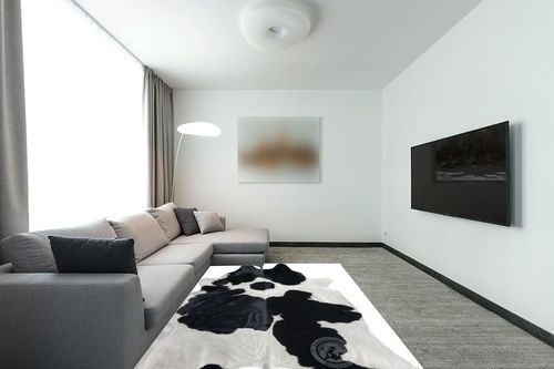 Genuine Black and White Cowhide Rug XL 6 x 7-8 ft. 180 x 240 cm in Modern Living Room with Grey Couch