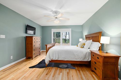 Sunshine Cowhides Genuine Black Cowhide Rug - Luxurious Cow Rug for Bedroom, Living Room, and Home Decor Enthusiasts - Masterpiece of Style and Functionality - 6x6-7ft (180x220cm) in Teal and Orange Wood Bedroom