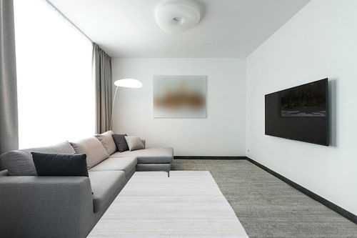 Antep Rugs Natural 5x7 Indoor Hand Woven Fiber Jute Area Rug (Off White, 5' x 7'6") in Modern Living Room with Grey Couch