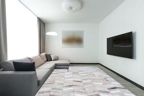 nuLOOM Cece Contemporary Cowhide Area Rug, 9' x 12', Silver in Modern Living Room with Grey Couch