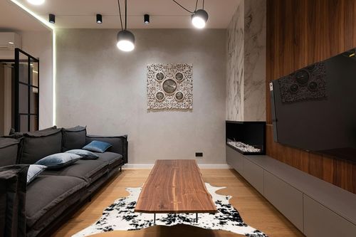 nuLOOM Marcia Machine Washable Faux Cowhide Area Rug, 5' x 6' 7", Black in Dark Wood Living Room with Black Couch