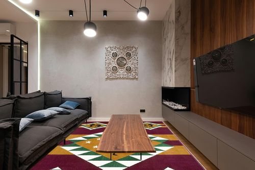 AllStar Rugs Red 8x10 Tribal Area Rug (7' 7" x 10' 6") in Dark Wood Living Room with Black Couch