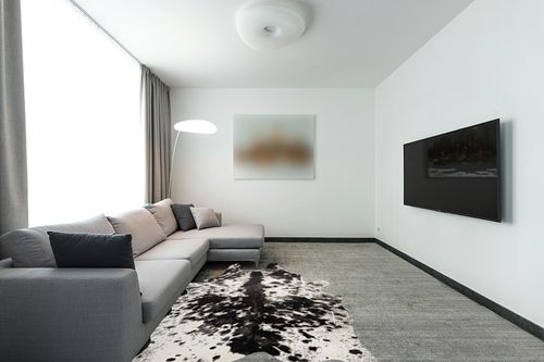 Yincimar Faux Cowhide Rug Extra Large Cow Print Area Rug 5.2ft x 6.6ft Non-Slip Animal Hide Carpet for Bedroom Living Room Western Home Office Decor (Black/Grey/White) in Modern Living Room with Grey Couch