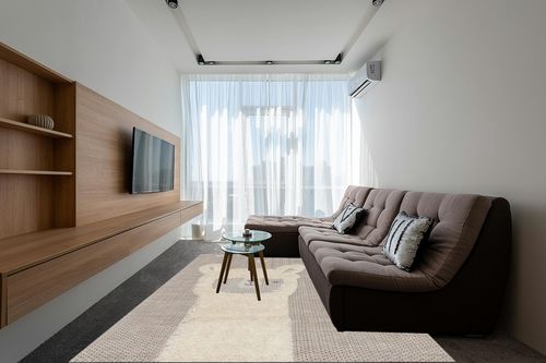 Valetta Abstract Beige Area Rug Isabelle & Max Rug Size: Rectangle 7'10" x 10'10" in Grey Living Room with Brown Couch