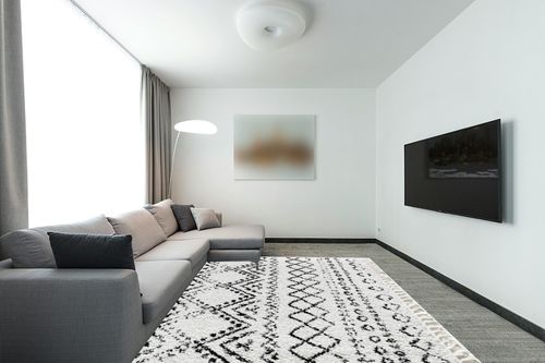 CosmoLiving by Cosmopolitan Wisp Area Rug, 8'0" x 10'0", Whisper White in Modern Living Room with Grey Couch