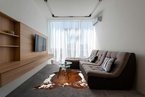 Sunshine Cowhides Genuine Brindle Tricolor Cowhide Rug - Luxurious Cow Rug for Bedroom, Living Room, and Home Decor Enthusiasts - Masterpiece of Style and Functionality - XL 6x7-8ft (180x220cm) in Grey Living Room with Brown Couch