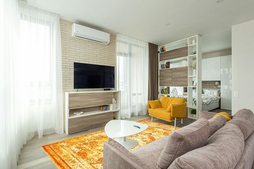 Unique Loom Sofia Collection Area Rug - Salle Garnier (6' 1" x 9' Rectangle, Orange/ Yellow) in Light Modern Living Room with TV