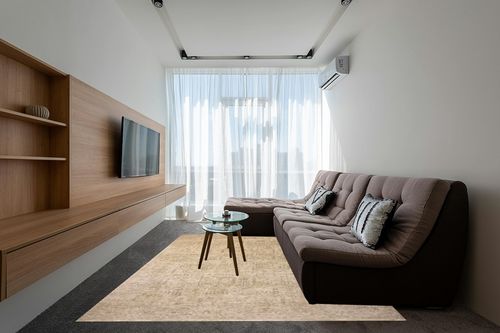 Loloi Magnolia Home by Joanna Gaines Junie Collection JUE-02 Oatmeal/Smoke 7'-10" x 10'-2", .38" Pile Height, Area Rug in Grey Living Room with Brown Couch