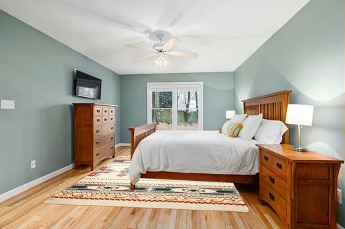 Ecuadane Large Southwestern Woven Blanket in Teal and Orange Wood Bedroom