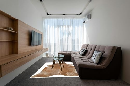 Genuine Palomino Beige Cowhide Rug 6 x 7-8 ft. 180 x 240 cm in Grey Living Room with Brown Couch