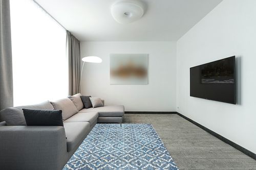 Linon Painterly Holmes Printed Lux Soft Faux Rabbit 5' X 7' Area Rug in Blue and White in Modern Living Room with Grey Couch
