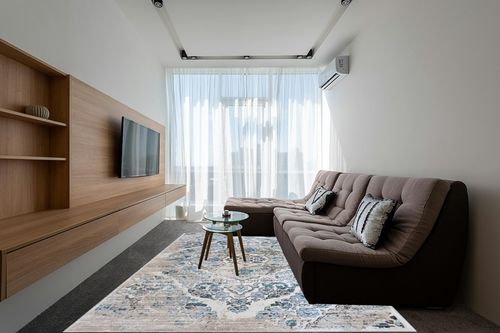 Cream Modern Stain Resistant, Durable, Fade Resistant Area Rug in Grey Living Room with Brown Couch