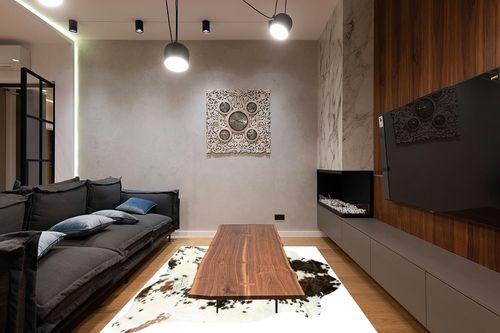 HIDES BAZAAR Light Tricolor Cowhide Rug, Premium Quality Genuine Leather Cow Hide, White, Brown and Black Color Mix Area Rug (6x7 ft) in Dark Wood Living Room with Black Couch