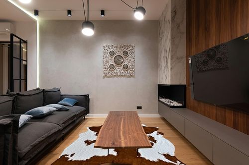 rugoo Faux Cowhide Rug 8.3 ft x 6.2 ft Cow Print Rug Faux Animal Skin Rug for Living Room Bedroom Nursery, White and Brown in Dark Wood Living Room with Black Couch