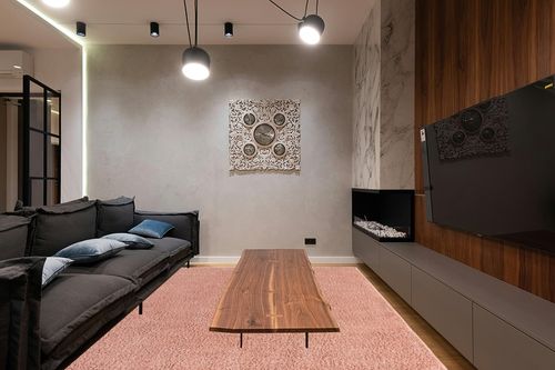 Pink Shag Rug Perfect in Dark Wood Living Room with Black Couch