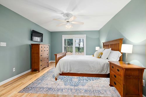 Loloi II Layla Collection LAY-07 Blue/Tangerine, Traditional 9'-0" x 12'-0" Area Rug in Teal and Orange Wood Bedroom