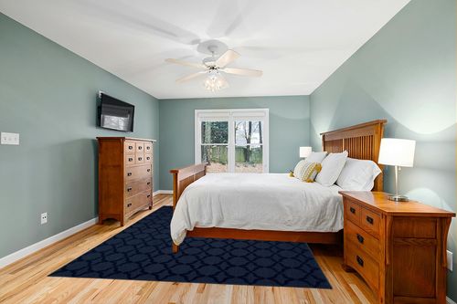 Garland Rug Sparta 8-Feet by 10-Feet Area Rug Navy in Teal and Orange Wood Bedroom
