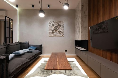 rodeo Exotic Brazilian Grey Brindle Cowhide Rug in Dark Wood Living Room with Black Couch