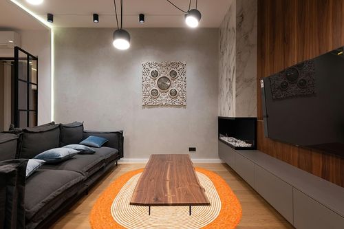 SAFAVIEH Braided Collection 6' x 9' Oval Orange/Ivory BRD904P Handmade Country Cottage Reversible Wool Entryway Foyer Living Room Bedroom Kitchen Area Rug in Dark Wood Living Room with Black Couch