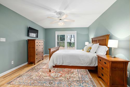 Loloi II Loren Terracotta/Sky 8'-4" x 11'-6" Area Rug in Teal and Orange Wood Bedroom