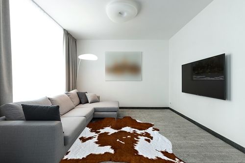 rugoo Faux Cowhide Rug 8.3 ft x 6.2 ft Cow Print Rug Faux Animal Skin Rug for Living Room Bedroom Nursery, White and Brown in Modern Living Room with Grey Couch