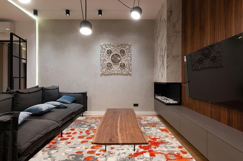 SAFAVIEH Madison Collection Area Rug - 9' x 12', Grey & Orange, Boho Abstract Distressed Design, Non-Shedding & Easy Care, Ideal for High Traffic Areas in Living Room, Bedroom (MAD425H) in Dark Wood Living Room with Black Couch