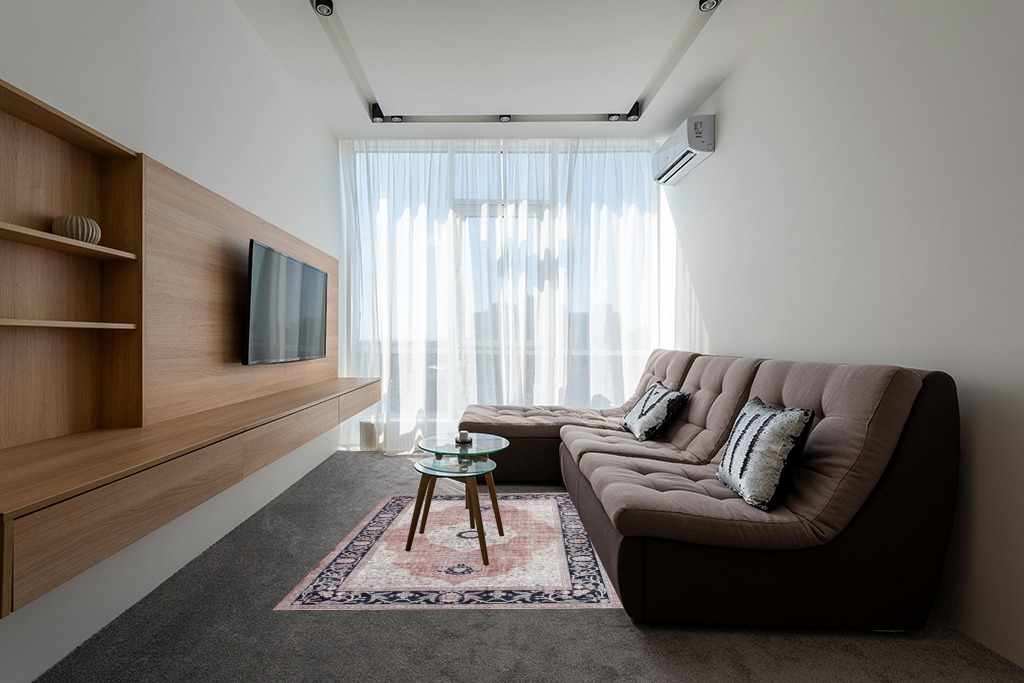 Rugs on grey carpet ideas in Grey Living Room with Brown Couch