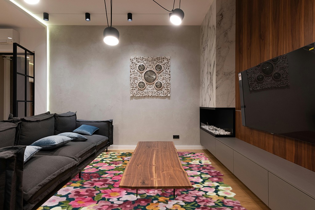 Restoration and Renovation Handmade Colorful Flower Silk & Wool Area Rug | Spring Garden Overflows The Frame | Unique Irregular Shape Hand-Tufted Floral Rug Perfect for Home Decor (5x8 Feet) in Dark Wood Living Room with Black Couch